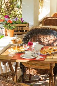 een houten tafel met borden met eten erop bij Hotel Villa Victoria de Tigre in Tigre