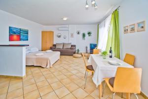 a living room with a bed and a table at HVAR apartments 8 min to the beach in Hvar