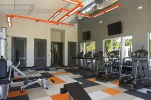 a gym with a lot of treadmills and ellipticals at 3840 Supreme Villa 6Bd Private Pool and Game Room in Kissimmee