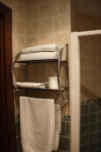 a towel rack with towels on it in a bathroom at Hotel Don Pero in Alora