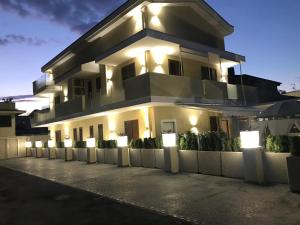 a large white building with lights in front of it at Residenza Carlucci in Angri