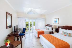 a hotel room with two beds and a television at Bay Gardens Marina Haven in Gros Islet