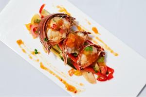 a plate of food with shrimp on a white plate at Bay Gardens Marina Haven in Gros Islet