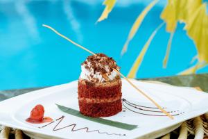 a piece of cake on a plate on a table at Bay Gardens Marina Haven in Gros Islet