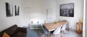a dining room with a wooden table and chairs at Stylish living with considered workspace in Norwich