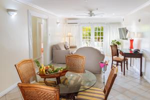 a living room with a table with a bowl of fruit at Bay Gardens Hotel in Gros Islet