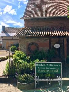 a building with a sign in front of it at HEINRICHs winery bed & breakfast in Langenlonsheim