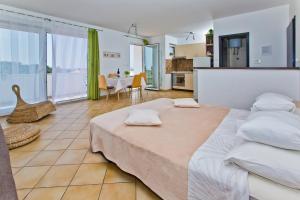 a large bedroom with a large bed and a kitchen at HVAR apartments 8 min to the beach in Hvar