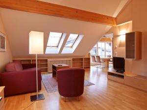 a living room with a ceiling with skylights at Holiday Apartments by Das Grüne Hotel zur Post - 100 % BIO & Villa Ceconi in Salzburg