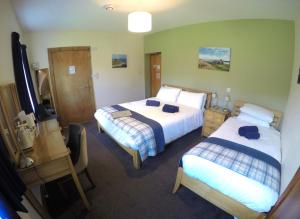 A bed or beds in a room at St Columba Hotel