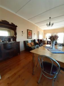 a living room with a table and a couch at Sutherland Guest House in Sutherland