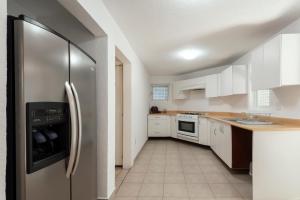 a kitchen with white cabinets and a stainless steel refrigerator at Beautiful apartment Ahuehuetes in Mexico City