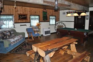 a living room with a ping pong table in it at Aspen Inn in Fort Klamath