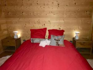 a bedroom with a red bed with two night stands at Residence le Paradis in Chamonix-Mont-Blanc