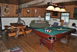 a living room with a pool table and a couch at Aspen Inn in Fort Klamath