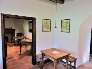 a room with two tables and a mirror at Agriturismo Piane in Ono Degno