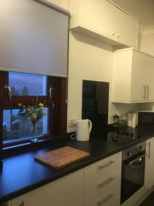 a kitchen counter with a cutting board and a window at situated at the heart of fort william in Fort William
