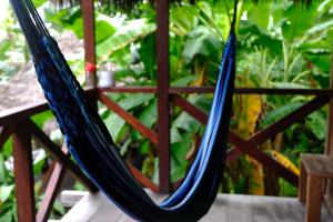 a couple of blue hammocks on a porch at Kachikine in Capurganá