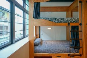 a bedroom with a bunk bed and a window at The Marion Hostel in Wellington
