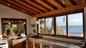 a kitchen with windows and a view of the ocean at Villa with Ocean View in Agulo