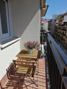 a balcony with a table and benches on a building at Belle Egia - Free Parking in San Sebastián