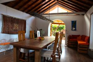 a dining room with a wooden table and chairs at Villa with Ocean View in Agulo