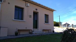 a house with a bench in front of it at casa carballal in Lorenzana