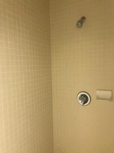 a shower with a shower head in a bathroom at Sunrise Inn in Turlock