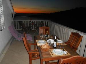 een tafel en stoelen op een balkon met een tafel en een tafel bij Villa Maria in Lastovo