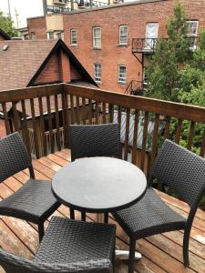 a table and chairs on a deck with a table and chairs at Bright, Clean, Private. In the Heart of Downtown! Parking, Wi-Fi and Netflix included in Ottawa