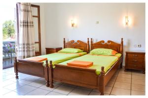 a bedroom with a wooden bed with green sheets at Blue Sky in Frý