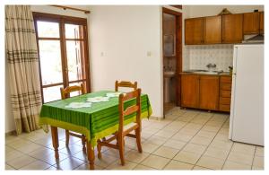 a kitchen with a table and chairs and a refrigerator at Blue Sky in Frý