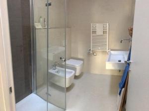 a bathroom with a shower and a toilet and a sink at PORTOPICCOLO sul Mare Sistiana in Sistiana