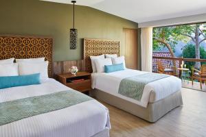 En eller flere senger på et rom på Secrets Papagayo All Inclusive - Adults Only