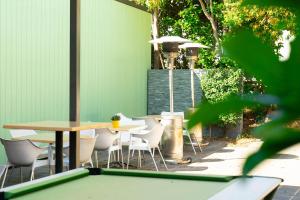 a ping pong table and chairs on a patio at Horse and Jockey Hotel Homebush in Sydney
