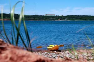 a toy animal sitting on the shore of a lake at Auberge la Salicorne et Escapades - Adventure Resort in Grande-Entrée