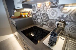 a kitchen with a counter with a cell phone on it at Casa Elisa Dimora Urbana in Modena