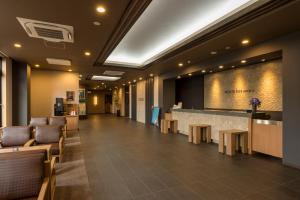 un vestíbulo de un hotel con bar y sillas en Hotel Route-inn Utsunomiya Yuinomori -Lightline Yuinomori Nishi-, en Utsunomiya