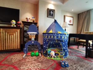 a childs room with a play set and a toy house at Royal Mediterranean Hotel in Guangzhou