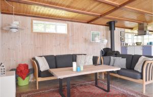 a living room with a couch and a table at Gorgeous Home In Hjslev With Kitchen in Højslev