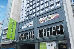 a building with a sign on the side of it at Hotel Ease Mong Kok in Hong Kong