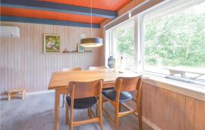 a dining room with a table and chairs and a window at Stunning Home In Hurup Thy With House A Panoramic View in Doverodde