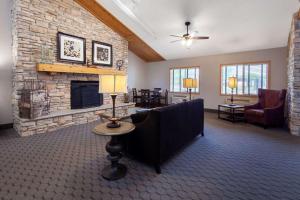 a living room with a couch and a fireplace at AmericInn by Wyndham Northfield in Northfield