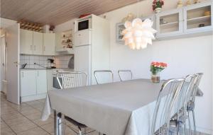 a kitchen and dining room with a table and chairs at Terrassehus in Fæbæk