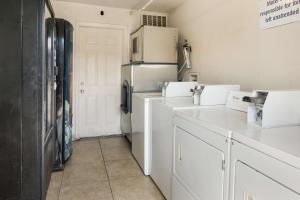 a kitchen with white cabinets and a refrigerator at Motel 6-Fort Worth, TX - Seminary in Fort Worth