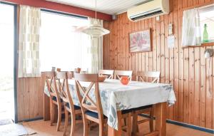 a dining room with a table and chairs at Holiday Home Lodbergsvej Ringkøbing Iii in Søndervig