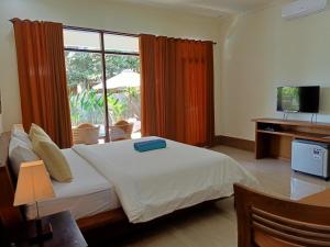 a bedroom with a bed and a large window at Two Brothers Villa in Gili Islands