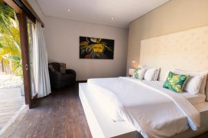 Ein Bett oder Betten in einem Zimmer der Unterkunft Seminyak Villa