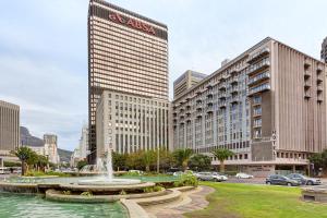 a fountain in the middle of a city with tall buildings at Fountains Hotel by Neighbourgood in Cape Town