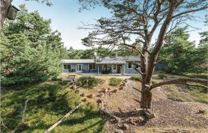 a home with a tree in front of it at Holiday Home I Klitterne Nexø I in Spidsegård +12 photos